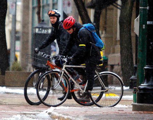 BORIS MINKEVICH / WINNIPEG FREE PRESS
Matt Veith, left/back, and Dan Russell, right/front, cycle through the exchange district on Albert Street Tuesday afternoon. Nov. 29, 2016