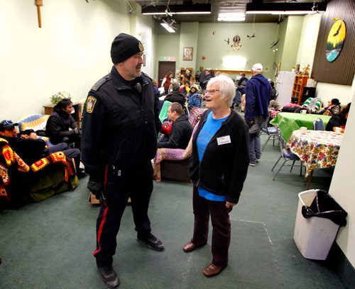 BORIS MINKEVICH / WINNIPEG FREE PRESS
MAIN STREET BEAT COP - Main street beat cop Kevin Burkett walks the beat on Main Street near Henry. L-R Here Burkett talks to The Cross staff Sister Johanna Jonker. Our Place Chez Nous Drop in Center Inc. is the formal name, but people know it as "The Cross". It's at 676 Main St.  Nov. 16, 2016