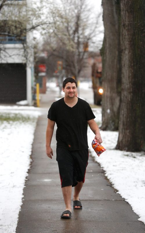 WAYNE GLOWACKI / WINNIPEG FREE PRESS
Jesse Richard strolls down Young St. in a T-shirt and shorts after grabbing a snack at a nearby store in the 0C temperature Wednesday morning. November 2016 is the warmest on record.  November 30 2016