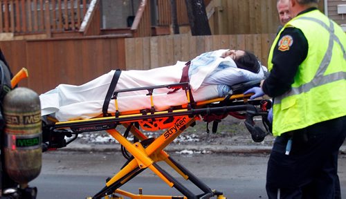 PHIL HOSSACK / WINNIPEG FREE PRESS -   City Paramedics wheel a victim away from a Maryland Street Apartment building Wednesday afternoon. At least one woman was taken to hospital after being carried out of the building. See Bill Redekopp story. November 30, 201