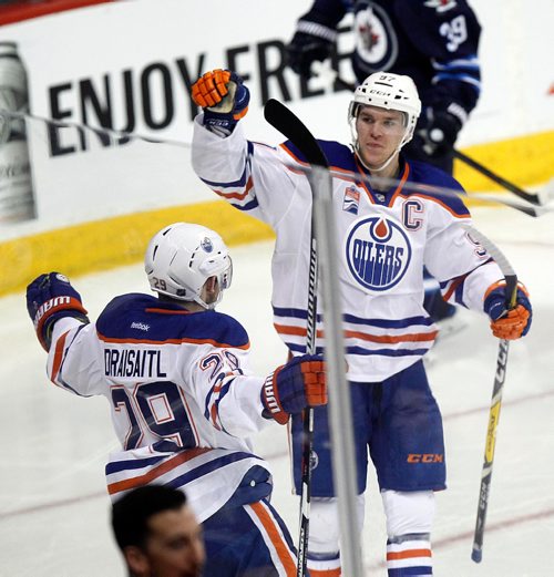 PHIL HOSSACK / WINNIPEG FREE PRESS - Edmonton Oilers #29 Leon Draisaitl celebrates with Connor McDavid in the Third period after scoring the 5th goal (of 6) against the Winnipeg JetsThursday at the MTS Center. December 1, 2016