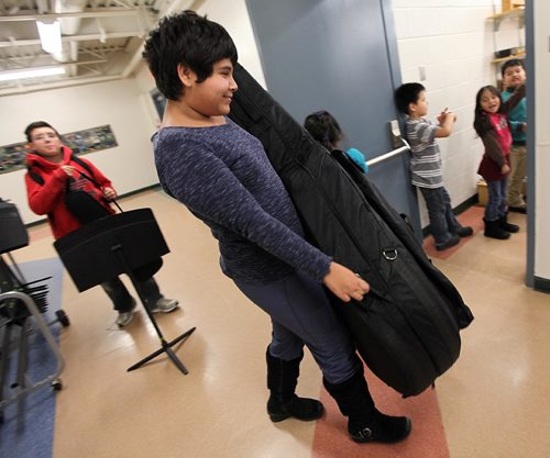PHIL HOSSACK / WINNIPEG FREE PRESS - D'asia Carriere wrangles her double bass to rehearsal. Students from King Edward School  are involved in the WSOs Sistema program, which aims to connect youth in undeserved areas with the pursuit of excellence in music education, spent the afternoon and evening practicing for an upcoming concert. See Melissa Martin's story. December 1, 2016