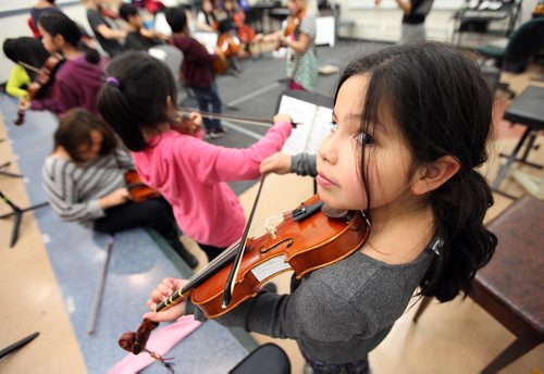 PHIL HOSSACK / WINNIPEG FREE PRESS - Zen-Veda  Prince-Kent young violinist peers up from her work Thursday afternoon. Students from King Edward School  are involved in the WSOs Sistema program, which aims to connect youth in undeserved areas with the pursuit of excellence in music education, spent the afternoon and evening practicing for an upcoming concert. See Melissa Martin's story. December 1, 2016