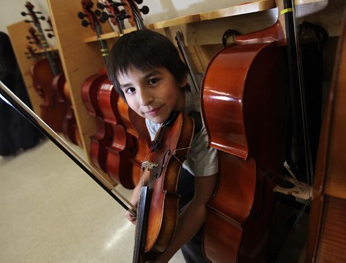 PHIL HOSSACK / WINNIPEG FREE PRESS - 10 yr old Lucas Howard poses with his violin before demonstrating the instrument Friday afternoon in the Sistema room at King Edward Community School.See Melissa Martin's story. December 1, 2016