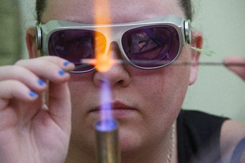 MIKE DEAL / WINNIPEG FREE PRESS
Ashlyn Noble creates glass beads to sell at her table during the Holiday Geek Market that The Winnipeg Geek Girls Social Club held in the Burns Family Classroom located in the Art Space Building in Winnipeg's Exchange District Sunday.
161204 - Sunday, December 4, 2016.