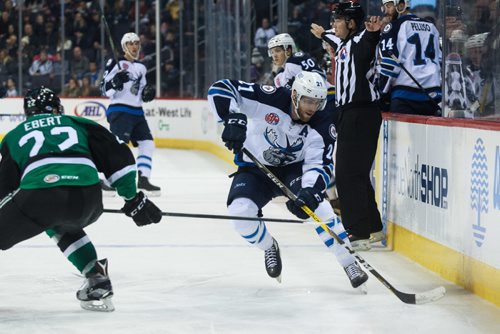 MIKE DEAL / WINNIPEG FREE PRESS
Manitoba Moose' Quinton Howden (21) takes the puck into the Texas Stars end past Stars' Nick Ebert (22) during an AHL game at the MTS Centre Sunday afternoon.
161204 - Sunday, December 4, 2016.