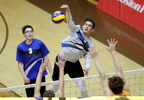 TREVOR HAGAN / WINNIPEG FREE PRESS
Selkirk Royals Nigel Nielsen hits over the Vincent Massey Vikings block in the high school volleyball championship, Monday, December 5, 2016.