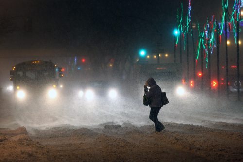 JOE BRYKSA / WINNIPEG FREE PRESS A pedestrian scrambles across Portage Ave and Edmonton St in downtown Winnipeg  The city and southern Manitoba will have winter storm/ blizzard conditions for the day-  Dec 06, 2016 -( standup Photo)