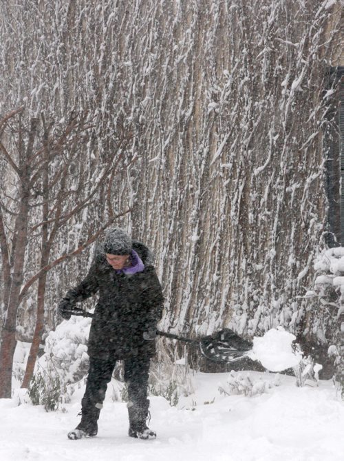 JOE BRYKSA / WINNIPEG FREE PRESS Jackie Garrett shovels on   Corydon Ave and Geulph St  in Winnipeg  The city and southern Manitoba will have winter storm/ blizzard conditions for the day-  Dec 06, 2016 -( standup Photo)