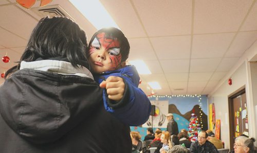 Canstar Community News A small boy awaits for the kick off of the 13th annual Lighting up The Avenue (LUTA) at the Ndinawe Youth Resource Centre (472 Selkirk Avenue) Dec.1.  Santa visited with children while others had hot beverages and stew. The evening was filled with speeches, prayers, and several performances. It also had a celebration ceremony for Powers Park, which consisted of a confetti canon. /Photo by Christina Hryniuk