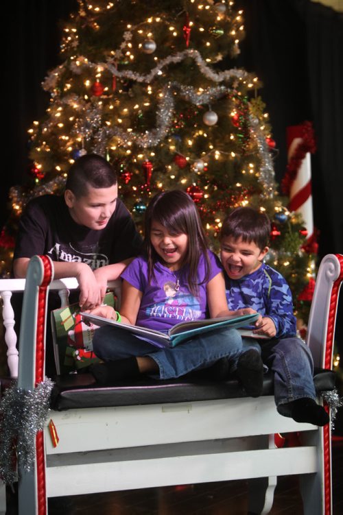 RUTH BONNEVILLE / WINNIPEG FREE PRESS


Christmas Books front - Eight-year-old Marley Hall reads, Naughty Mabel sees it all by Nathan Lane & Devlin Elliott to her little brother Johnny (5yrs) and their cousin, Junior Cote looks on at the Metis Friendship Centre.  
Names of books:
Naughty Mabel sees it all by Nathan Lane & Devlin Elliott. The Day Santa Stopped Believing in Harold - words by Maureen Fergus & Pictures by Cale Atknson, A Boy Called Christmas by Mat Haig with illustrations by Chris Mould (chapter book). 
Dec 7, 2016
