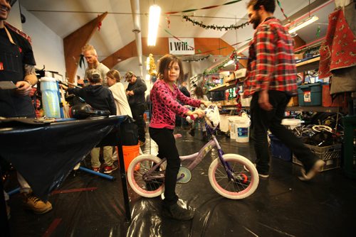RUTH BONNEVILLE / WINNIPEG FREE PRESS

Caitlyn Zastre - 8yrs tests out a bike after it was fixed during Cycle of Giving marathon Saturday.   She was just one of hundreds of volunteer mechanics and helpers of all ages that converged on Rossbrook House during  a 24 hour kids bike building marathon event.  The goal: to turn trailers full of kids bikes recuperated from the Brady landfill into 350+ holiday presents for kids in need, all the while hoping to raise $15,000 to provide bicycle programming for Winnipeg youth throughout the year.
See story.

 Dec 10, 2016