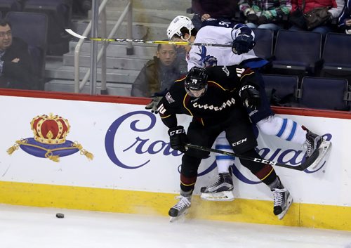 TREVOR HAGAN / WINNIPEG FREE PRESS
Cleveland Monsters Dean Kukan (14) hits Manitoba Moose Jack Roslovic (50) hard into the boards during second period AHL action, Saturday, December 10, 2016.