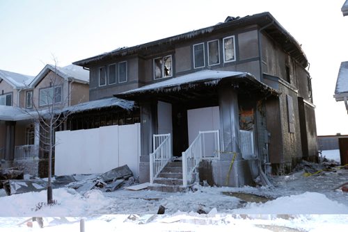 WAYNE GLOWACKI / WINNIPEG FREE PRESS

A steady flow of onlookers were passing by the home on Rose Garden Crescent in Bridgwater Lakes Tuesday morning after it was heavily damaged by a fire Monday night. No injuries reported. see caption on Phils photos. Dec. 13 2016