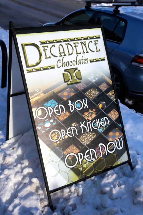 BORIS MINKEVICH / WINNIPEG FREE PRESS
Decadence Chocolates on Sherbrook St.  Sign on curb in front of store. Dec. 13, 2016