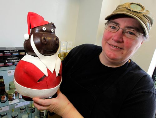 BORIS MINKEVICH / WINNIPEG FREE PRESS
Decadence Chocolates on Sherbrook St.
Owner Helen Staines poses with one of the Christmasy chocolate creations she makes for the holiday season. This is a over 2kg chocolate pig.  Dec. 13, 2016