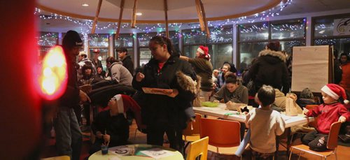 Canstar Community News Families gather in the Indigenous Family Centre to eat snacks, drink hot chocolate, draw, color, and visit Santa Clause. /Photo by Christina Hryniuk