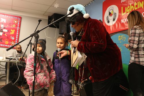 Canstar Community News Two small girls start singing Christmas carols for the attendees before going outside to see the confetti canon. /Photo by Christina Hryniuk