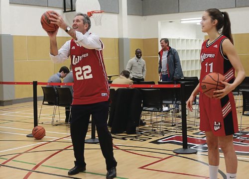 Canstar Community News Manitoba Premier Brian Pallister  (left) and hid daughter Shawn Pallister, a forward post for the womens Wesmen basketball team  compete in a shoot out on Dec. 6 at the kick-off for Wesmens 50th anniversary. /Photo by Christina Hryniuk
