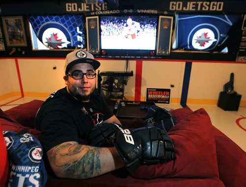 PHIL HOSSACK / WINNIPEG FREE PRESS -   Kyle Calder, who has converted his basement into the second coming of the MTS Centre; lines painted on the floor... hockey boards as walls... TV as game clock etc etc Dave Sanderson story.  - December 13, 2016