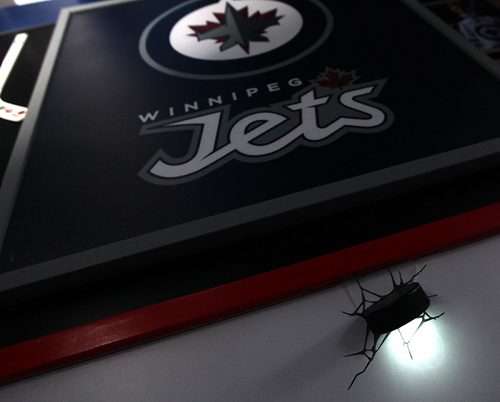 PHIL HOSSACK / WINNIPEG FREE PRESS -   Kyle Calder, who has converted his basement into the second coming of the MTS Centre; lines painted on the floor... hockey boards as walls... TV as game clock etc etc.... A hockey Puck embedded in the "boards acts as a mood light. Dave Sanderson story.  - December 13, 2016