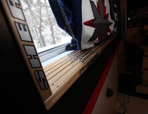 PHIL HOSSACK / WINNIPEG FREE PRESS -  Window sills and casings are finished with hockey stick shafts. Kyle Calder, who has converted his basement into the second coming of the MTS Centre; lines painted on the floor... hockey boards as walls... TV as game clock etc etc Dave Sanderson story.  - December 13, 2016