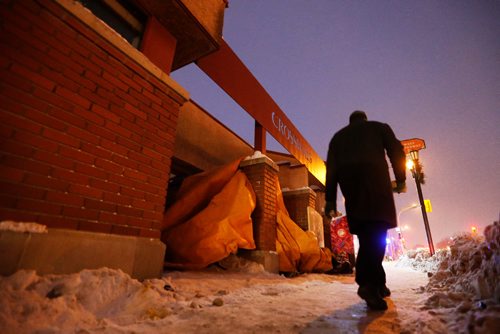 JOHN WOODS / WINNIPEG FREE PRESS
A man takes a wide berth as he walks past "John's" 4x6ft homemade shelter on Broadway without stopping Tuesday, December 13, 2016. The city is abuzz with new found concern for people living on the street after a woman died on the street yesterday

