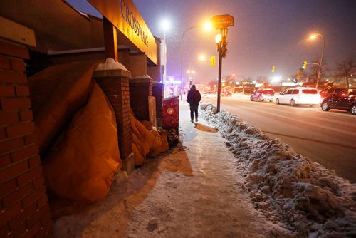 JOHN WOODS / WINNIPEG FREE PRESS
A man walks past "John's" homemade 4x6ft shelter on Broadway without stopping Tuesday, December 13, 2016. The city is abuzz with new found concern for people living on the street after a woman died on the street yesterday

