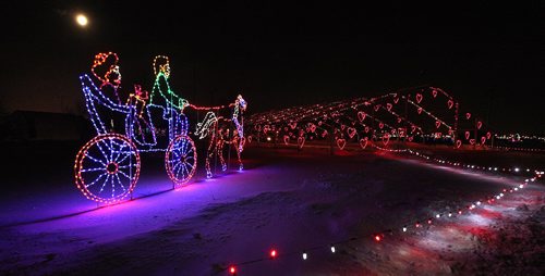 PHIL HOSSACK / WINNIPEG FREE PRESS - Cars, vans, busses  and a horse drawn Carraige under a full moon file through the Canad Inns Winter Wonderland Christmas lighting display at the Red River Exhibiton Grounds Tuesday evening. Stand-up. - December 13, 2016