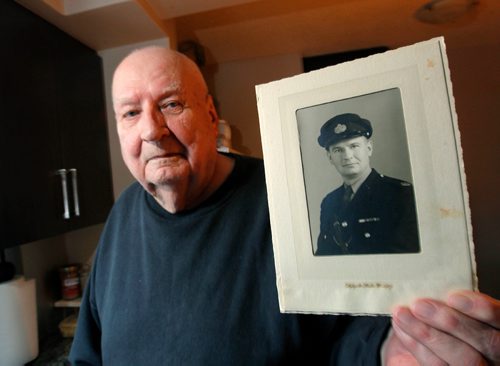 BORIS MINKEVICH / WINNIPEG FREE PRESS
Former Winnipeg police officer Gilbert Johnson, age 92 at end of the month, who in the summer of 1969 attended with his cop partner to a domestic call in Fort Rouge where they were met outside the home by a man in his early 20s with a knife in one hand and another knife in the other. Goes with police news conference about the use of de-escalation or talking down, instead of taking down emotionally disturbed individuals. Here he holds an old photo of when he was a traffic cop in the 60s. GORD SINCLAIR STORY. Dec. 14, 2016
