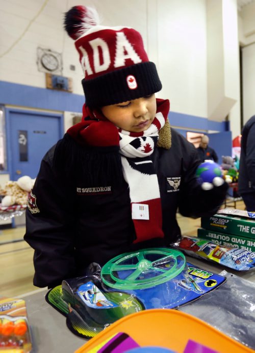 WAYNE GLOWACKI / WINNIPEG FREE PRESS

Desmond,10,  looks for gifts for his family at the pop-up set up in the R. B. Russell Vocational High School Thursday. The store is put on by Think Shift, a local marketing company, which donates everything for the event to give less fortunate kids a chance to shop, for free, for Christmas gifts for their families. Ashley Prest story.  Dec.15 2016
