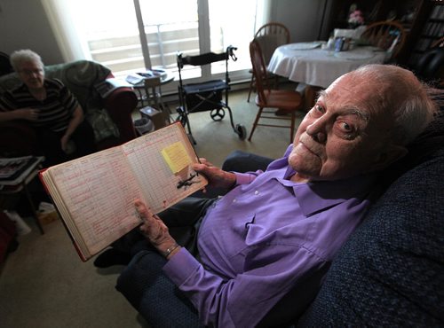 PHIL HOSSACK / WINNIPEG FREE PRESS - Ian Thomson flips through his pilot's log, a photo of the Halifax Bomber her flew in the bottom right corner. He piloted bombing runs over Germany 44 times in Halifax Bombers in WW2.  See Kevin Rollason's story. , 2016