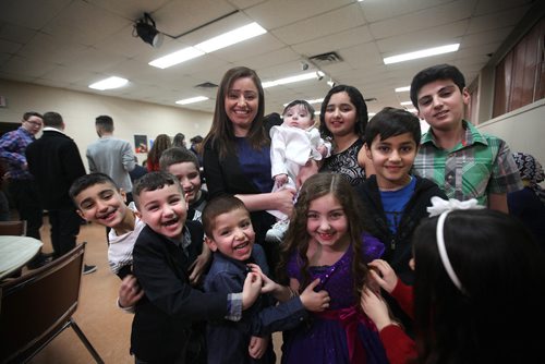 RUTH BONNEVILLE / WINNIPEG FREE PRESS

Nafiya Naso (woman) has her photo taken with Yazidi kids from the local Yazido community including one of the youngest in the group, 5 month old Rayan Abdulkareem, during feast in celebration of Eida Rojia, the end of their three-day Decemnber fast at Temple Shalom Friday evening.  They are also celebrating the good news they just received that two more Yazidi refugee families will arrive in Winnipeg next week.
See Carol Sanders story.   


 Dec 16, 2016