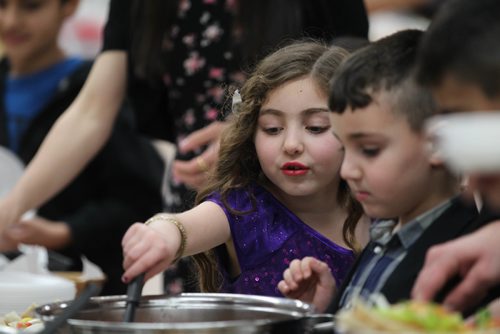 RUTH BONNEVILLE / WINNIPEG FREE PRESS

Local kids from the  Yazido community fill their plates with homemade, traditional Yazidi dishes during feast in celebration of Eida Rojia, the end of their three-day Decemnber fast at Temple Shalom Friday evening.  They are also celebrating the good news they just received that two more Yazidi refugee families will arrive in Winnipeg next week.
See Carol Sanders story.   


 Dec 16, 2016