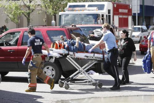 WINNIPEG, MAN: JUNE 25, 2008 -- Fire crews work on one of the victims of a car crash that killed two and sent another three to the hospital in Winnipeg, Man. June 25, 2008. Accident happened at Donald Street and St. Mary Ave at 4:20pm.  BORIS MINKEVICH / WINNIPEG FREE PRESS
