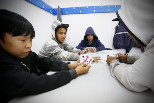 JOHN WOODS / WINNIPEG FREE PRESS
From left, Odin Annanaut Christopher Ikuutaq, Johnny Andy and Chris Muckpah play the traditional card game Amu during a community dance in Baker Lake September 22, 2016
