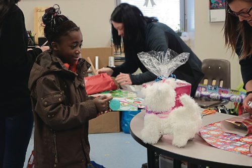 Canstar Community News Therese Mwarabu, 9, from David Livingstone School, plays with the toy she chose for her little brother at Make Nice Happen on Dec 15, 2016.