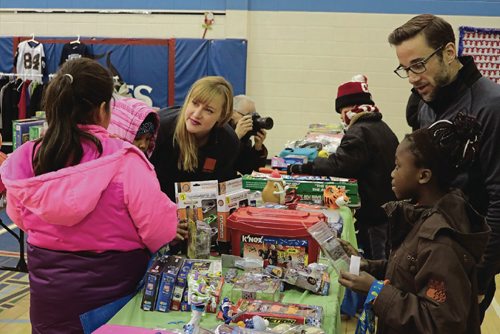Canstar Community News Kids entered the R.B. Russell Vocational High Schools gym to pick up to three gifts for their loved ones at Make Nice Happen on Dec. 15, 2016.