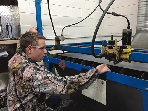 Canstar Community News Dec. 14, 2016 - Philipp Kaster, a Grade 11 metal fabrication student at Murdoch MacKay Collegiate, demonstrates the school's CNC plasma cutter and the plasma cam software. Students at Murdoch have been manufacturing and selling custom metal coathangers, proceeds of which go to the United Way of Winnipeg's Koats for Kids campaign. Since 2011, Murdoch MacKay has raised over $10,000 for the campaign. (SHELDON BIRNIE/CANSTAR/THE HERALD)