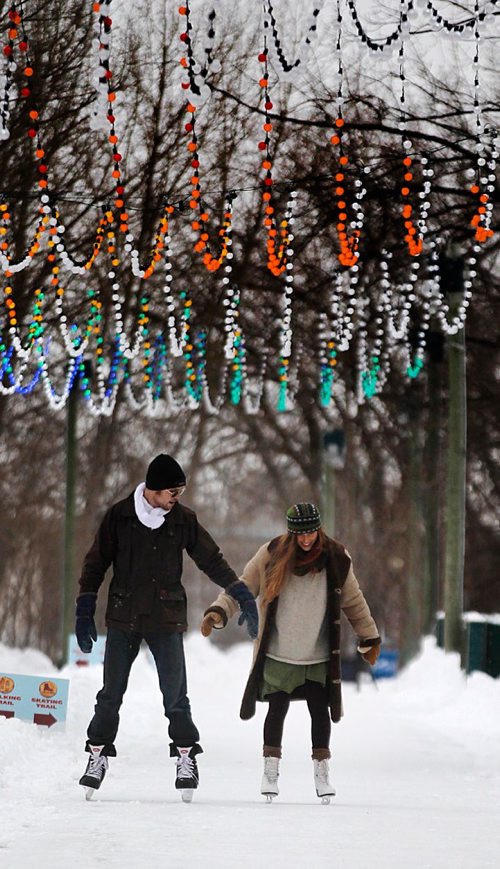 PHIL HOSSACK / WINNIPEG FREE PRESS -  Skaters James Patterson and Francisca Matos make their way along some of the ice skating trail at the Forks, the circle under the canopy and about a kilometre of trail connecting a skating rink in front of the Scotia Bank Stage are ready for the warm weather this week.  - December 19, 2016