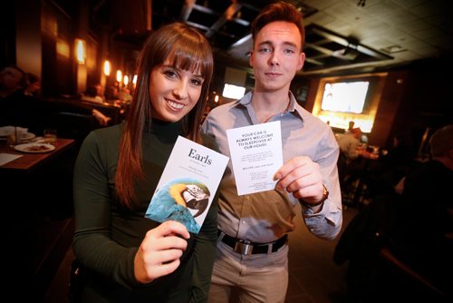JOHN WOODS / WINNIPEG FREE PRESS
Katie Takatch and Austin Campbell, marketing manager for Earls, show off their Car Sleepover program at their Polo Park restaurant Tuesday, December 20, 2016. If customers leave their cars in the parking lot after drinking at their restaurant a $10 coupon is left on their car.
