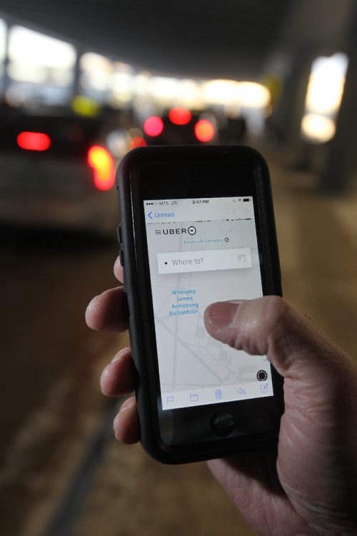 RUTH BONNEVILLE / WINNIPEG FREE PRESS

Uber ride service story.  Photo illustration of person holding phone opening Uber App to get ride instead of using local taxi service.  
See Bill Redekop story.  

 Dec 21, 2016