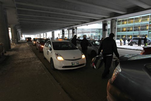 
RUTH BONNEVILLE / WINNIPEG FREE PRESS

Unicity Taxi driver Sukhjinder Sidhu carries a passengers luggage to his  taxi at  airport Wednesday.  Unicity Taxis line up on arrival deck at Winnipeg James Armstrong Richardson International Airport.

See Bill Redekop story.  

 Dec 21, 2016