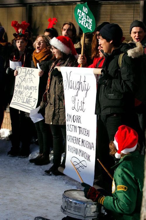 BORIS MINKEVICH / WINNIPEG FREE PRESS
A group of concerned citizens protest the recent approval of Kinder Morgan and Line 3 pipelines in front of MP for Winnipeg South Centre and Minister of Natural Resources Jim Carr's office at 611 Corydon. They sang Christmas carols with the words changed to reflect their protest message. Dec. 22, 2016