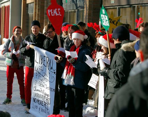 BORIS MINKEVICH / WINNIPEG FREE PRESS
A group of concerned citizens protest the recent approval of Kinder Morgan and Line 3 pipelines in front of MP for Winnipeg South Centre and Minister of Natural Resources Jim Carr's office at 611 Corydon. They sang Christmas carols with the words changed to reflect their protest message. Dec. 22, 2016