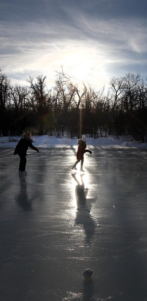 PHIL HOSSACK / WINNIPEG FREE PRESS -  The early bird gets....clean ice!! A pair of skaters enjoy the freshly flooded Duck Pond at Assinaboine Park Thursday afternoon. Park preparations include officially opening ther skating pond and tobogan run to welcone visitors over the holidays.  Starting Friday Kids have free admission at the Zoo as well. (See story / release) - December 20, 2016