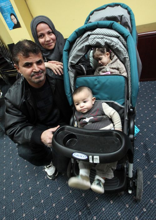 PHIL HOSSACK / WINNIPEG FREE PRESS -  Wasel Alanis, his wife Gousoun Hamoud and ther daughter Arij 2yrs,  and son Mosatfa 5 months, pose with the family's new stroller.  Kevin ROllason story. - December 23, 2016