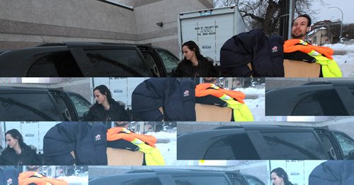 PHIL HOSSACK / WINNIPEG FREE PRESS - Katie Schimnowski and Ian Cherry pose with a Main Street Project van and a bundle of warm clothing, part of the emergency supplies they expect to hand out from the van over the holidays. See Alex Paul's story..  - December 23, 2016