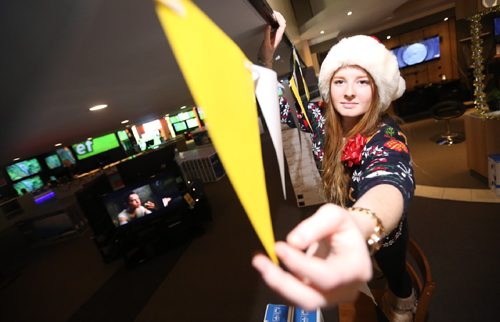 TREVOR HAGAN / WINNIPEG FREE PRESS
Brooke Flanagan hangs decorations in preparation for Advance's boxing week sales known as the Krazy Karnival, Saturday, December 24, 2016.