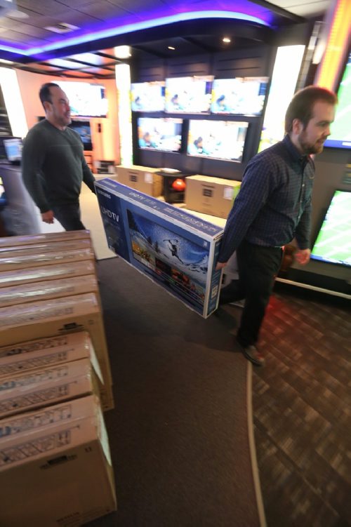 TREVOR HAGAN / WINNIPEG FREE PRESS
Alec Markusoff and Riley S. move inventory in preparation for Advance's boxing week sales known as the Krazy Karnival, Saturday, December 24, 2016.